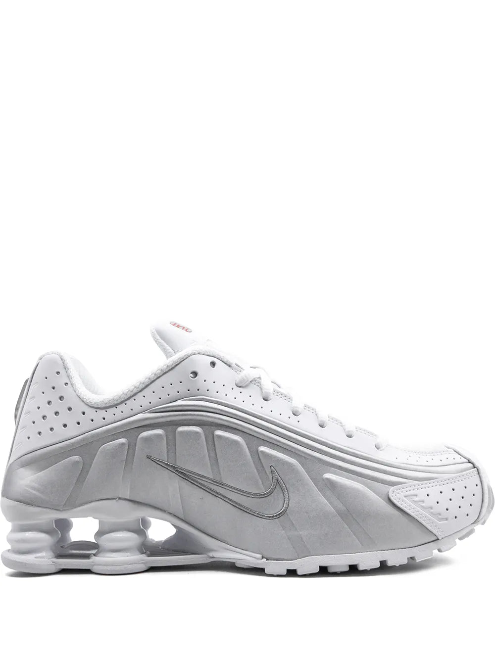 Nike Shox R4 white sneakers with perforations, Swoosh, and chunky gray midsole.