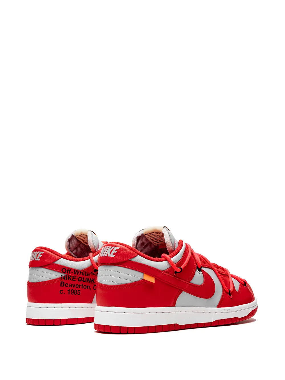 Red low-top sneaker pair with rear Nike logo and printed heel text, white midsole.