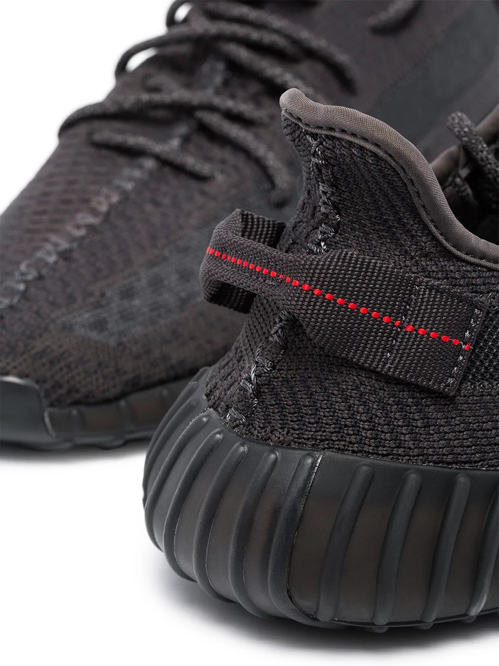 Black Yeezy Boost 350 V2 sneaker detail, braided laces and ribbed sole