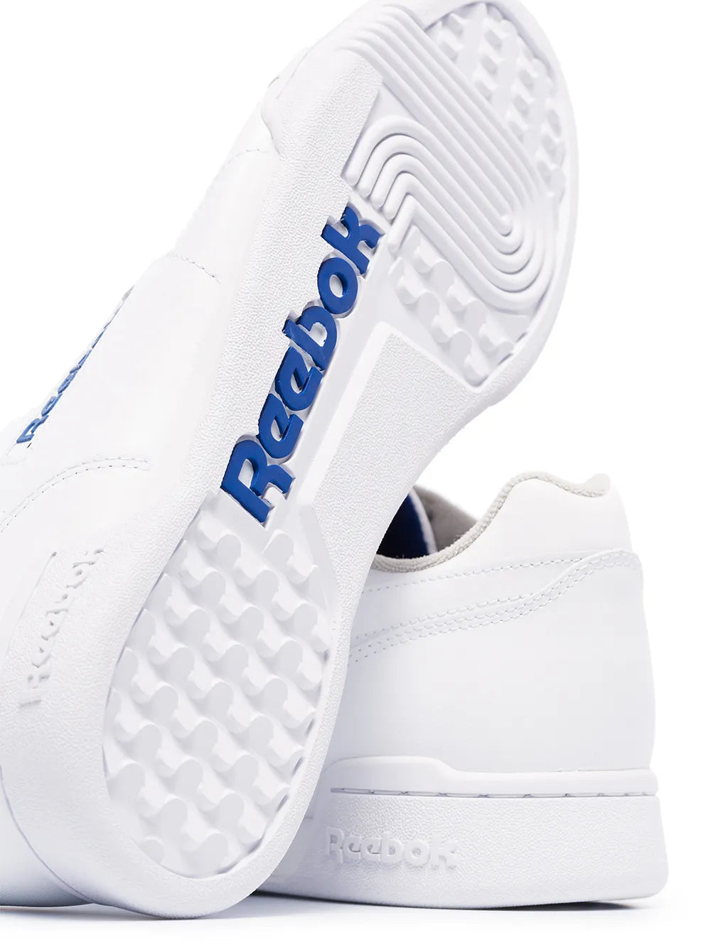 White Reebok low-top sneaker with textured outsole and blue Reebok detail