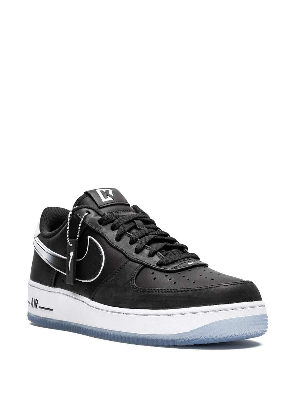 Black low-top lace-up sneakers with white swoosh and light-blue outsole