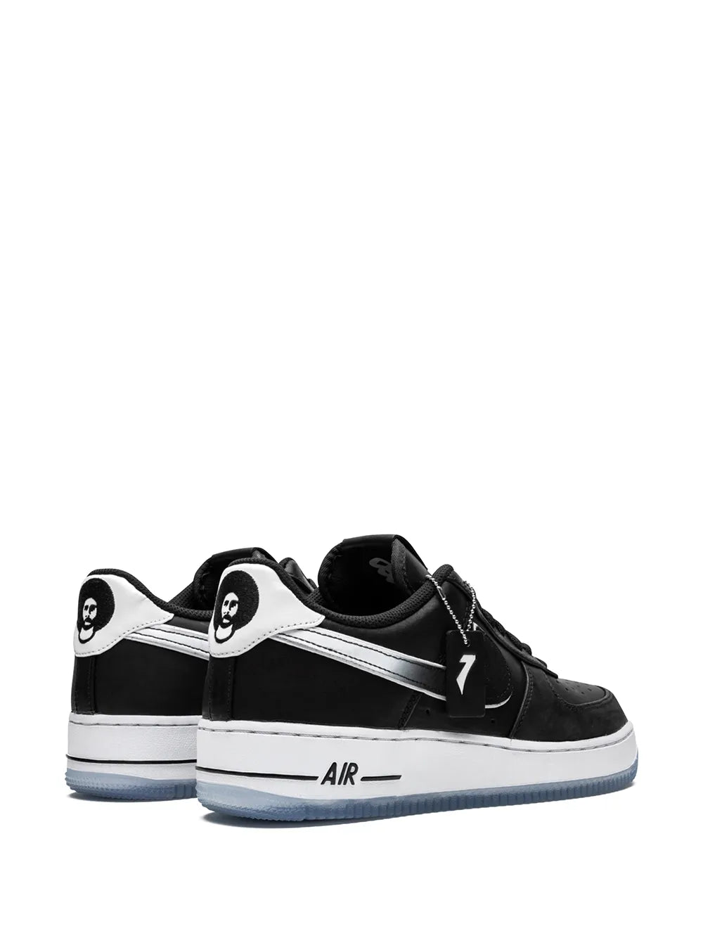 Black low-top sneakers with white heel panels and light-blue outsole