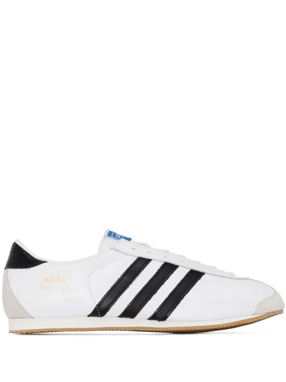 White leather training sneakers with black adidas stripes and gum sole
