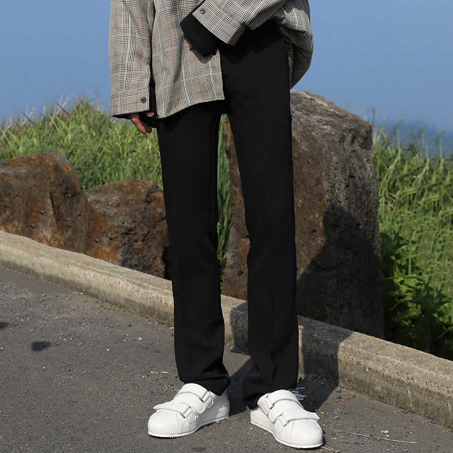 Black loose straight trousers with wide leg opening and clean, minimal seams