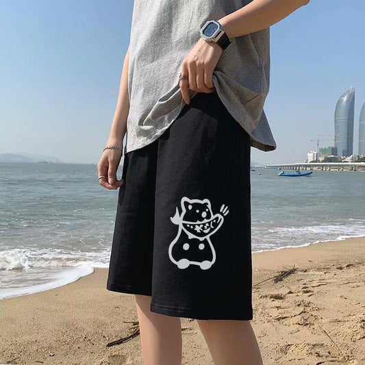 Black straight sports shorts with white cartoon cat graphic on the leg