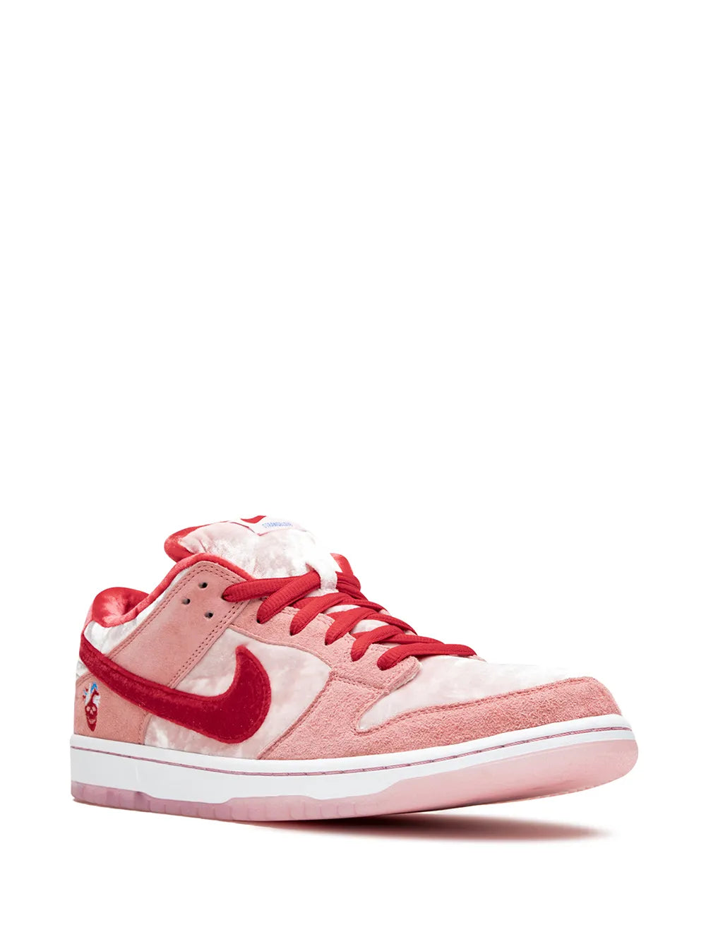 Low-top skate shoes with white panels, pink upper, red laces and Nike swoosh