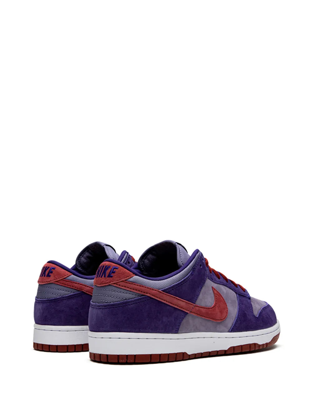 Purple low-top Nike sneakers with orange swoosh, red laces, and heel logo
