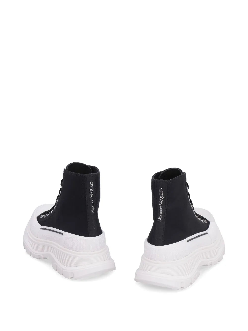 Black high-top sneakers with white platform heel and lace-up closure, back view