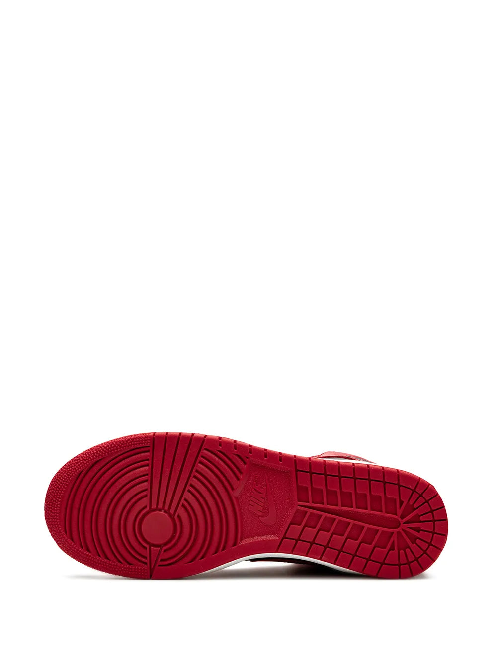 Rubber outsole of red high-top sneakers with herringbone tread and circular logo