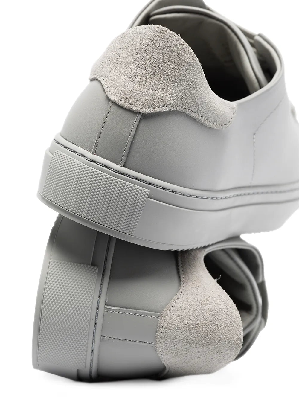 Light gray low-top sneaker with suede collar and padded heel, lace-up