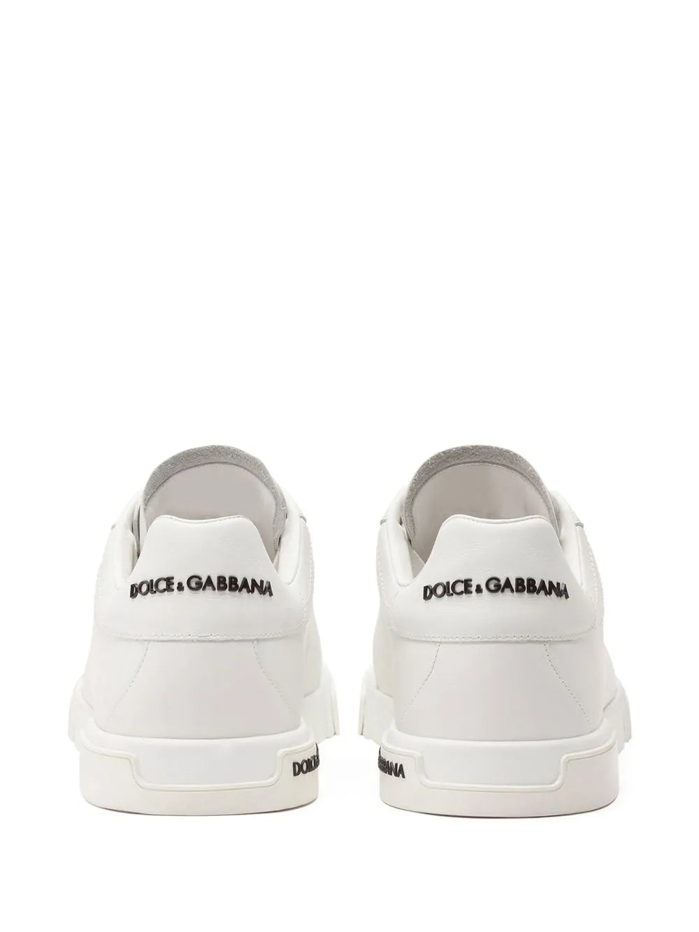 Back view of white low-top sneakers with Dolce&Gabbana logo at heel tabs