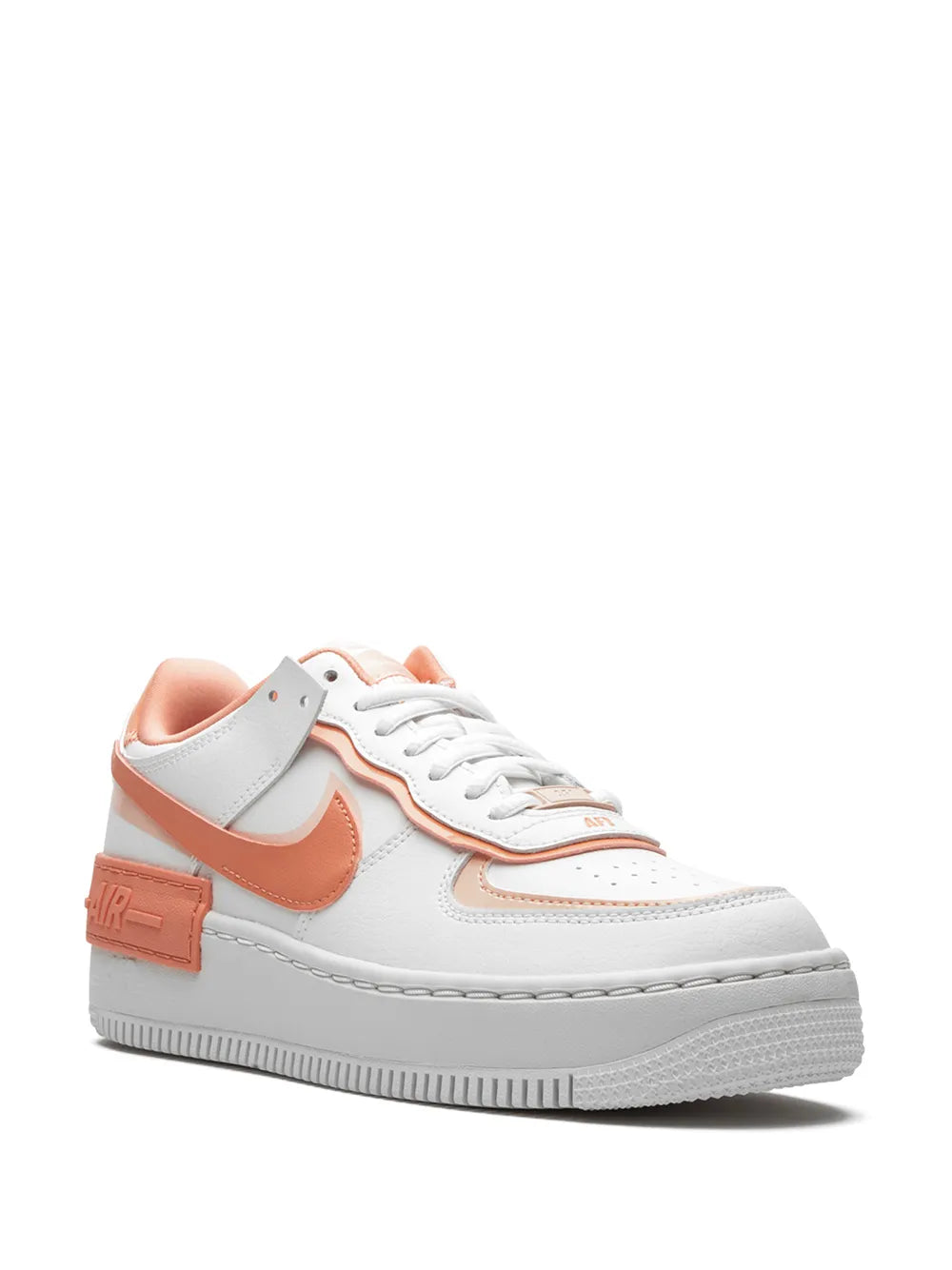 Side view of white, gray and coral Nike lace-up sneakers with swoosh