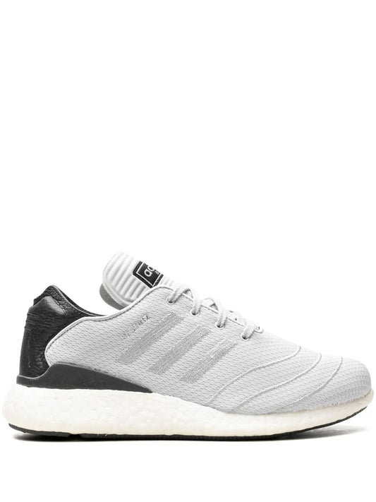 White knit low-top sneaker with black heel panel and lace-up front