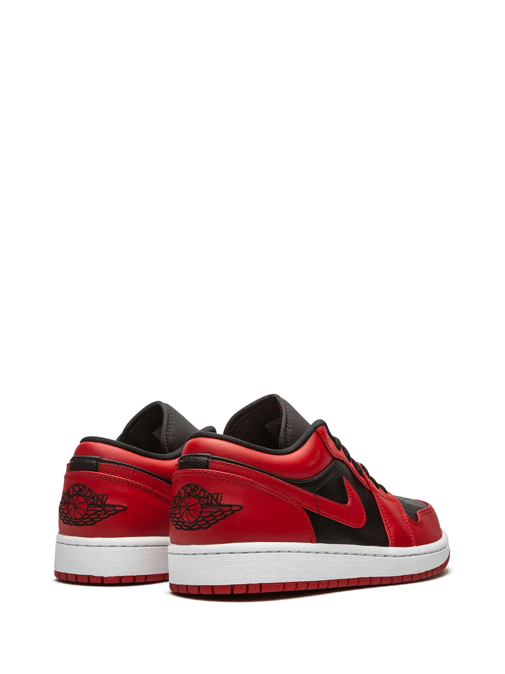 Red low-top sneakers with black heel panels, black Swoosh, and white sole