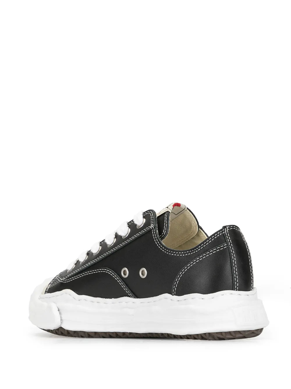 Black low-top lace-up sneakers with contrast stitching, white laces, and thick white sole