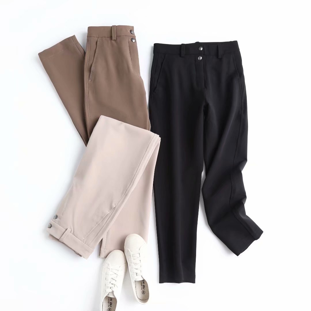 Straight casual trousers in taupe and black, each with two-button front and belt loops