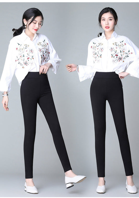 Black slim casual pants with white side stripe detailing and tapered ankle cuffs