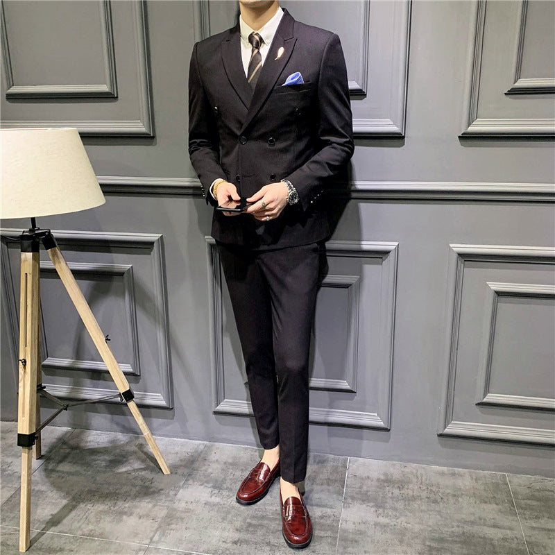 Men's black double-breasted suit with pocket square, dress shirt and burgundy loafers