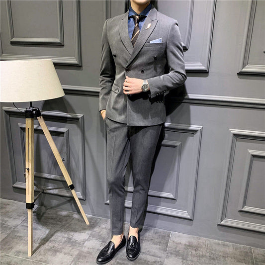 Men's gray double-breasted suit with notch lapels and blue pocket square over dress shirt
