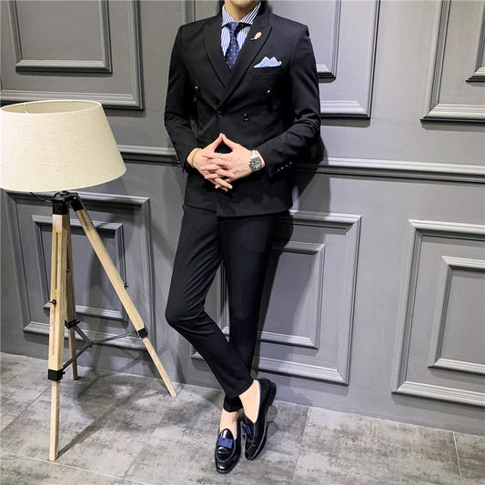 Men's black double-breasted suit with notch lapels, striped dress shirt, pocket square
