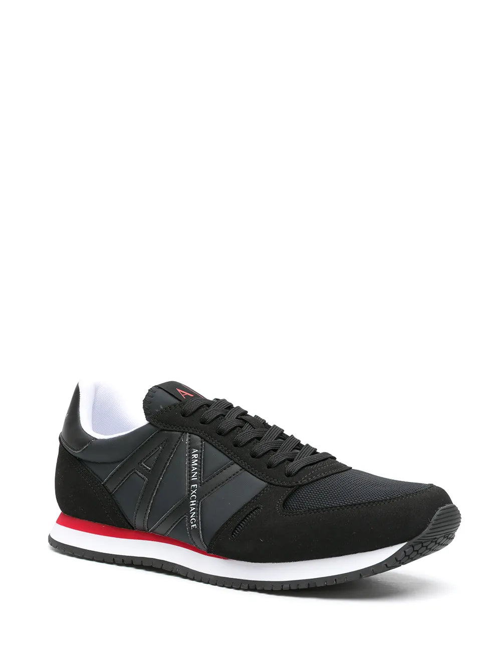 Black low-top sneakers with logo patch and red/white sole stripe