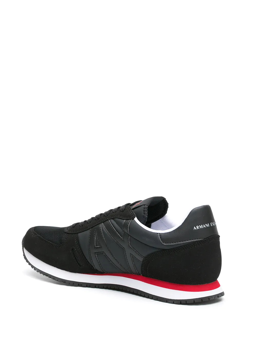 Black low-top sneakers with heel logo patch and red/white sole stripe