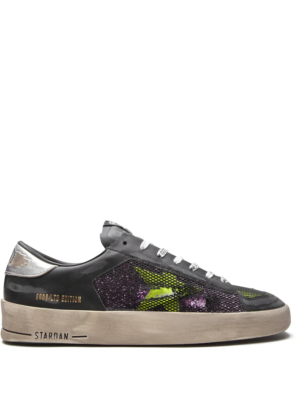 Low-top sneakers with black glitter panels and neon green and purple accents, beige sole