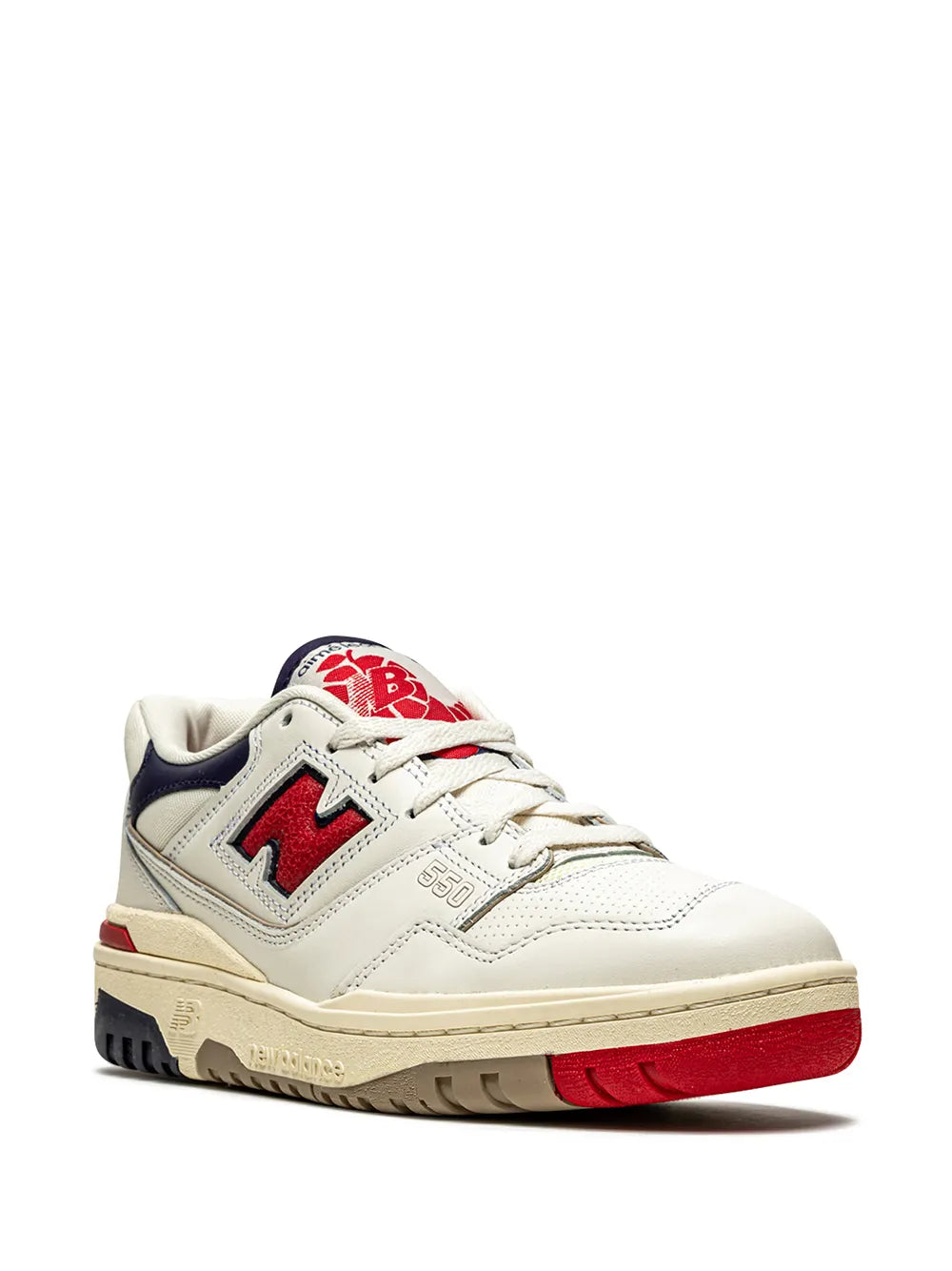 White sneakers with navy heel tab, red laces, red sole stripe, cream outsole