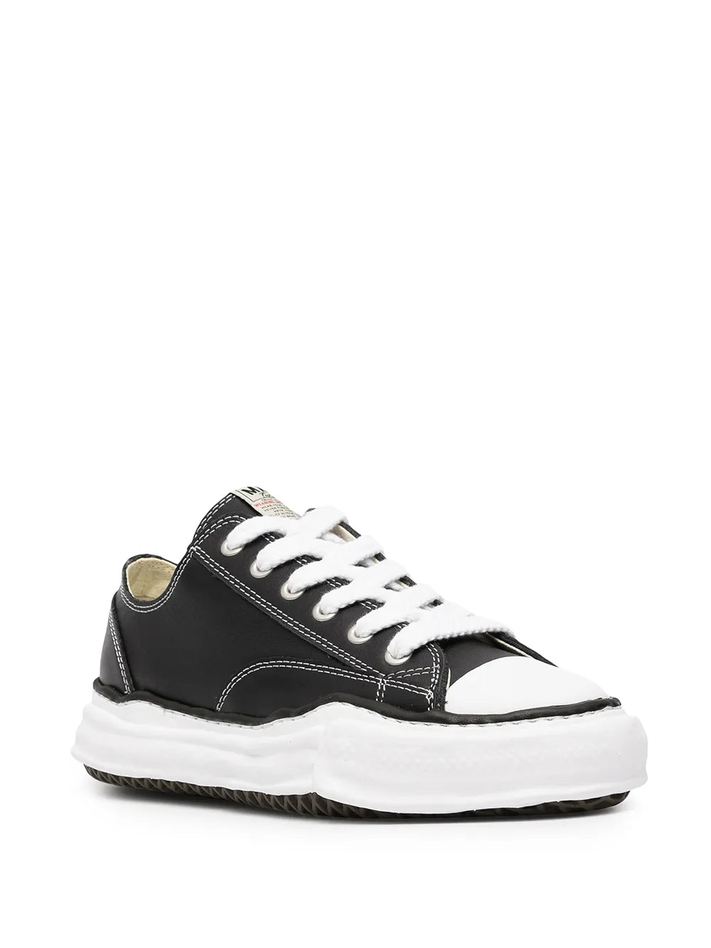 Black low-top sneakers with white laces, contrast toe cap, and white rubber sole