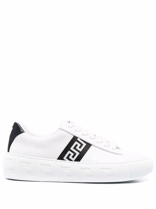 White low-top sneaker with black greca-style side emblem and platform rubber sole