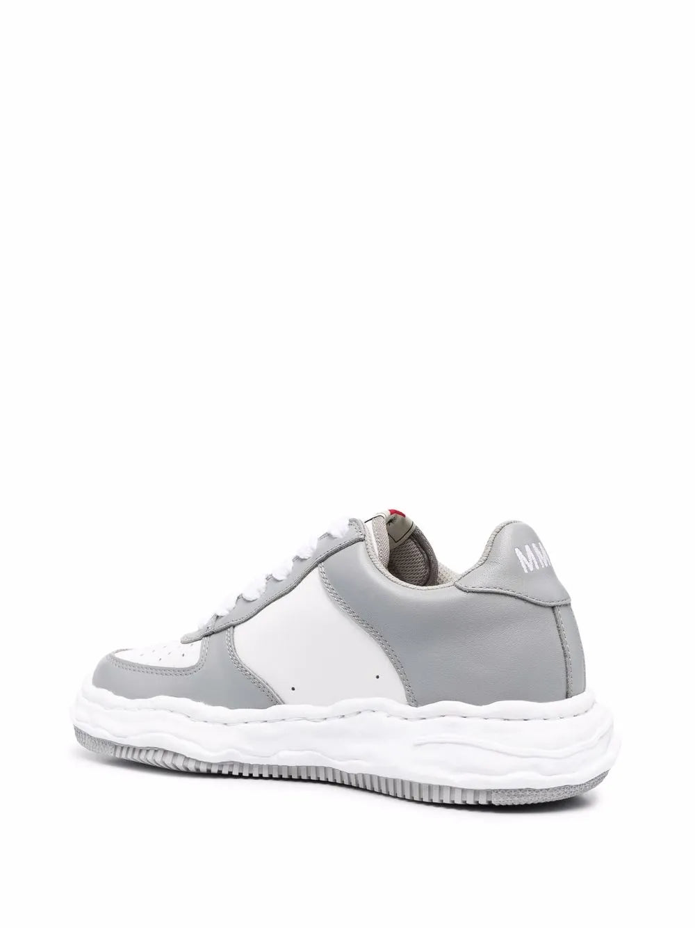 Light gray and white chunky sneakers with rear logo patch and thick rubber sole