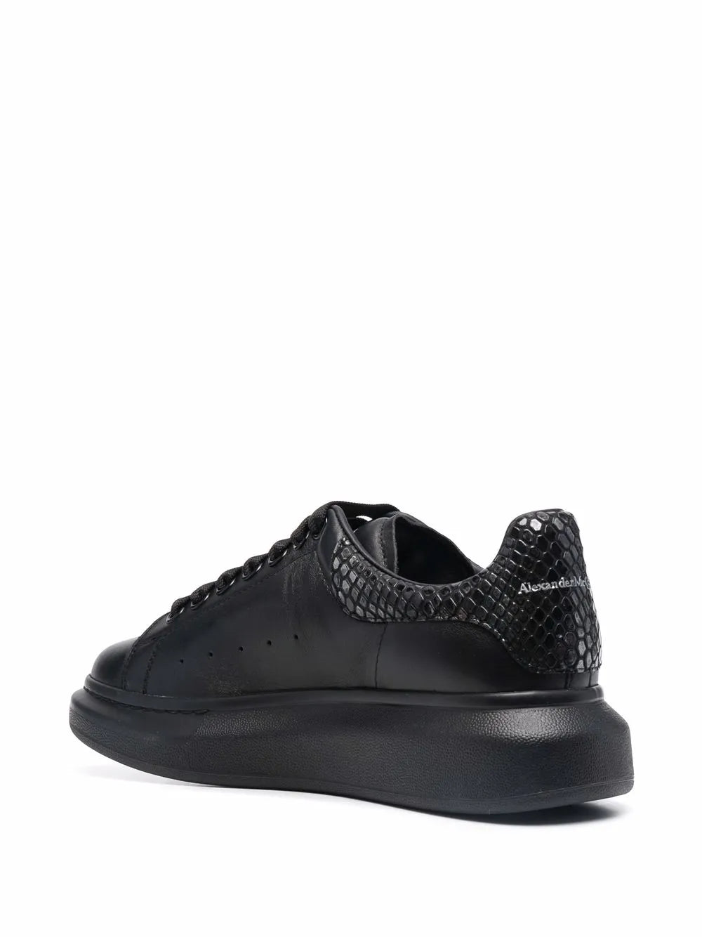 Black lace-up sneakers with snakeskin-effect heel and side panel detail, rubber sole