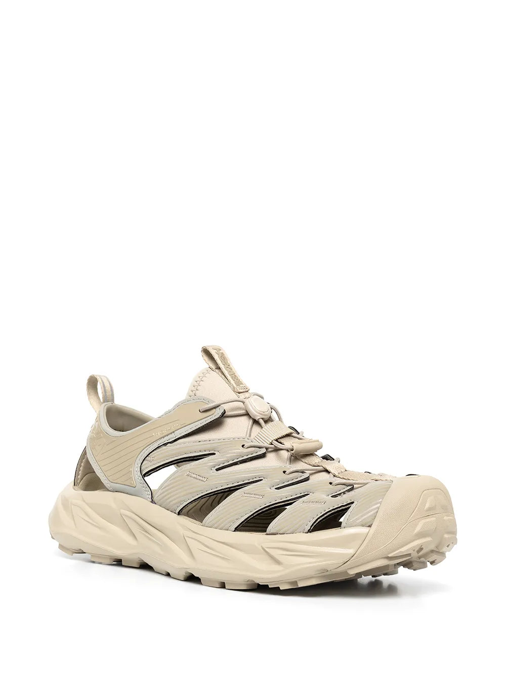 Beige lace-up low-top sneakers with black side stripes and thick molded outsole