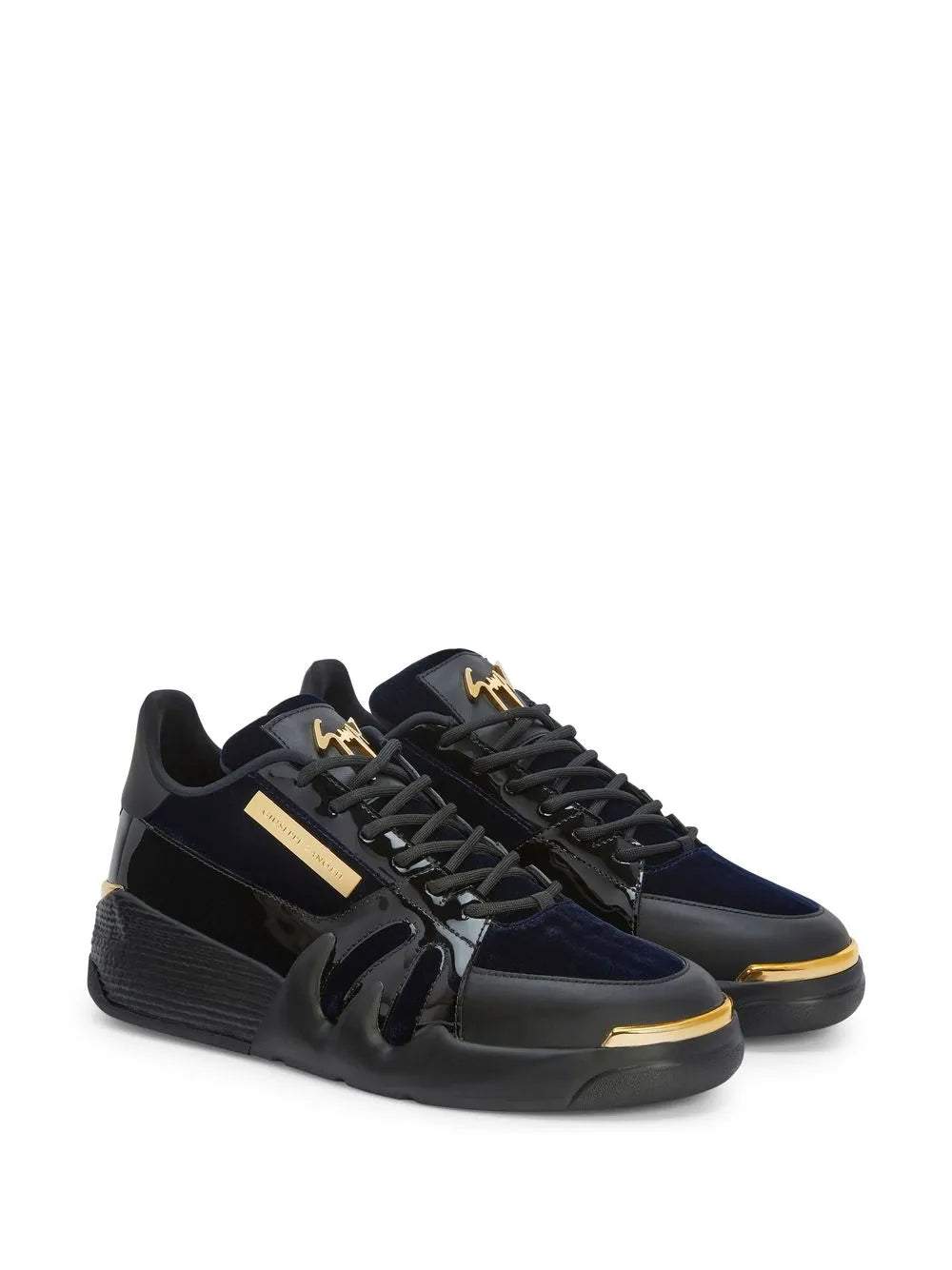 Navy and black low-top sneakers, gold lace tips, chunky rubber sole
