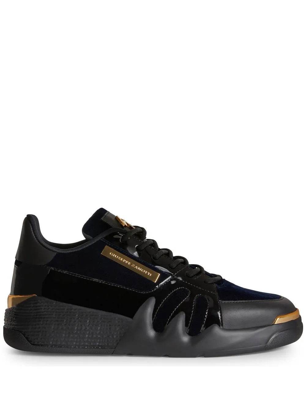 Dark low-top sneakers with black laces and gold side logo trim