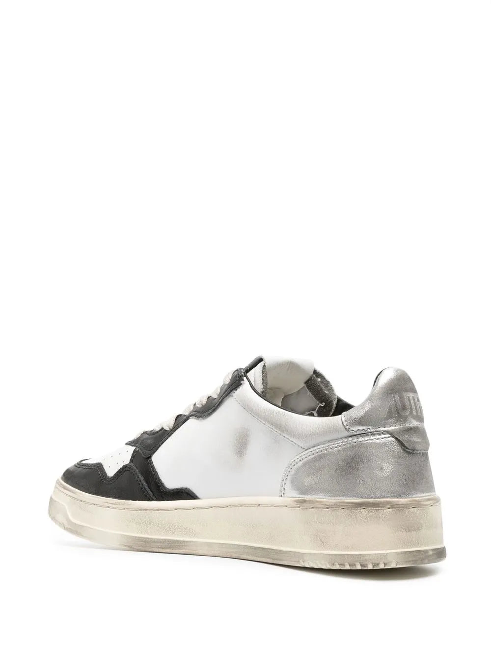 White and black low-top sneakers with off-white sole, rear heel lace-up view
