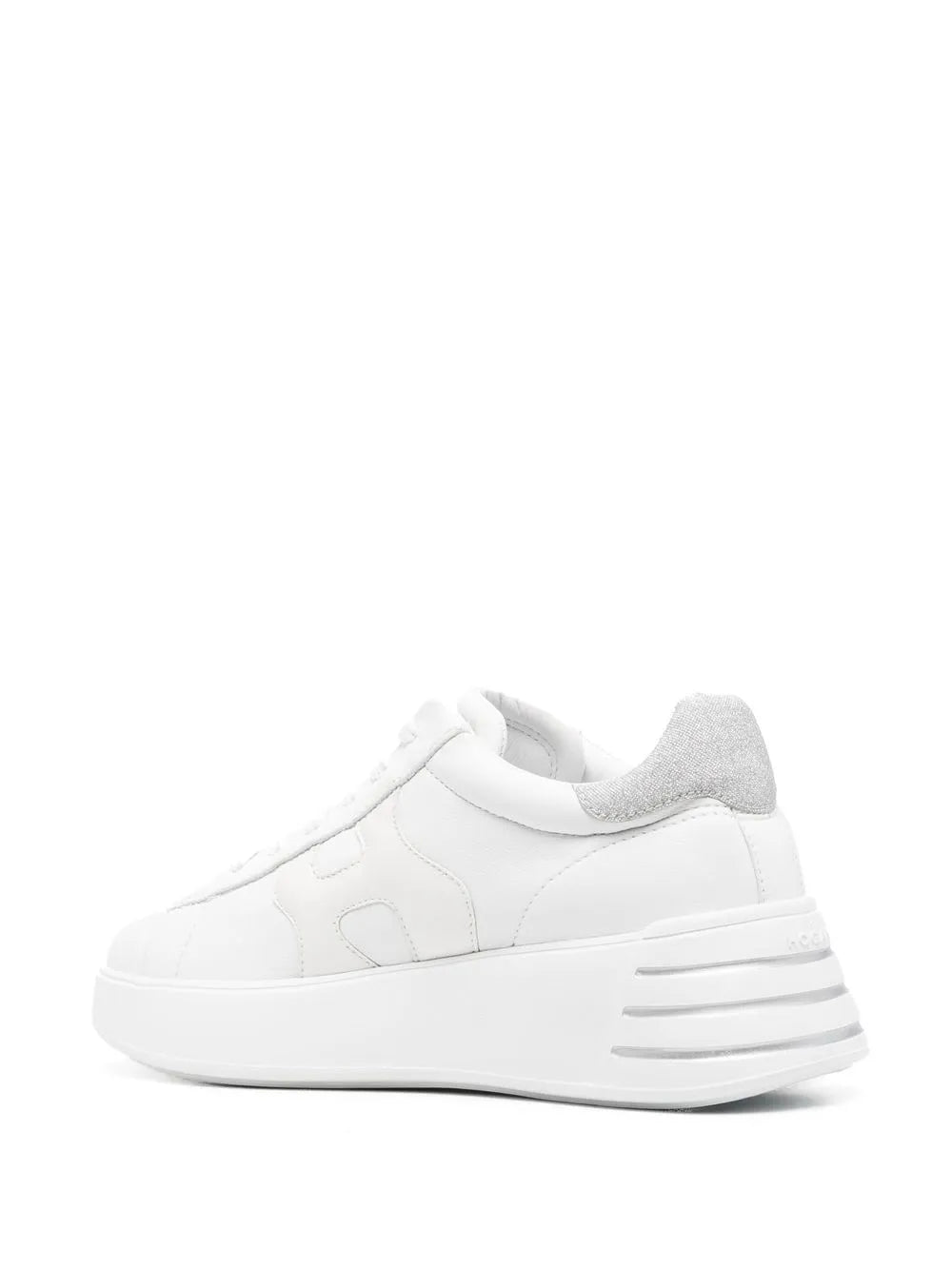 White low-top sneakers with light gray heel lining and striped side accents