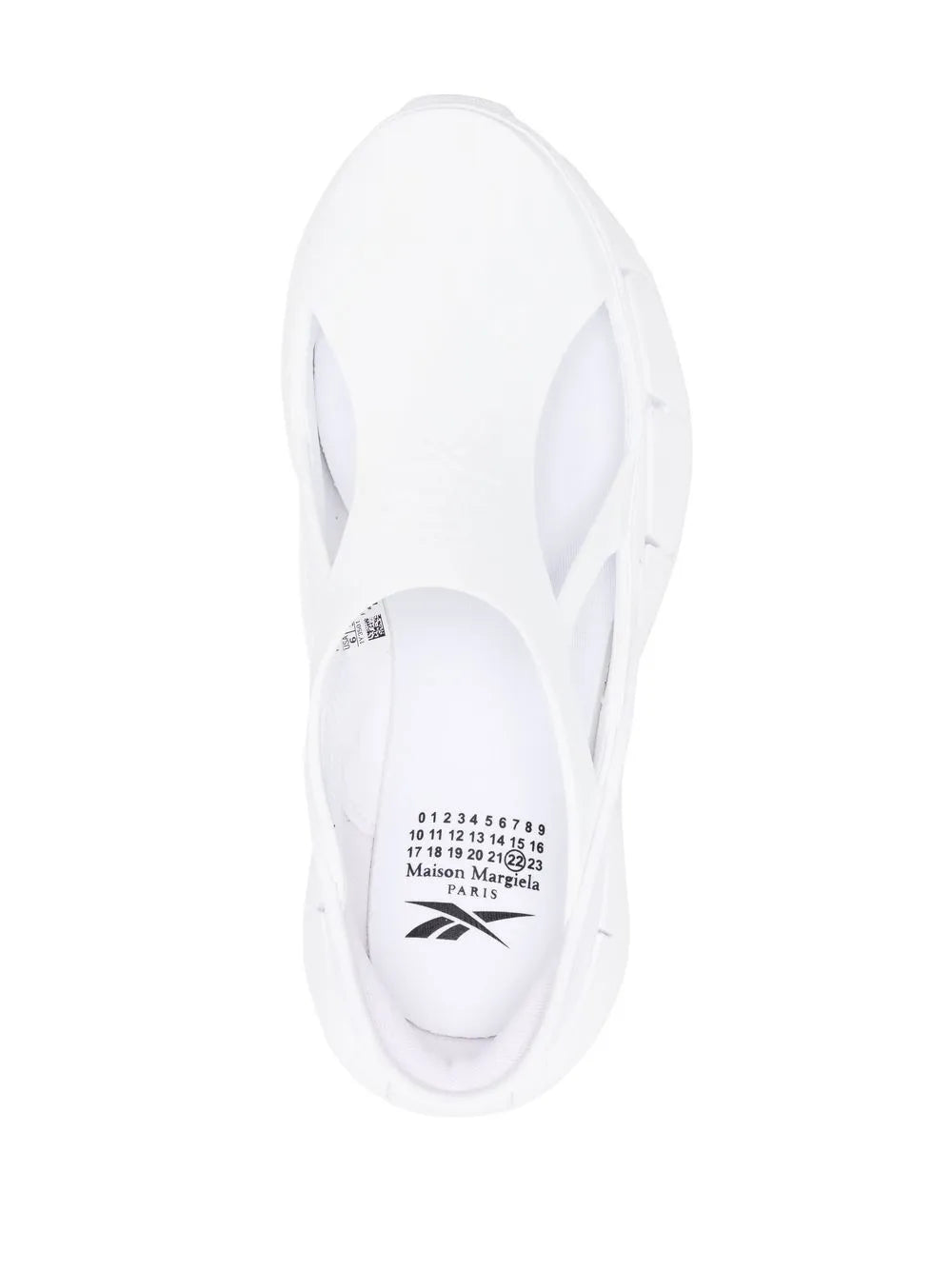 White Maison Margiela sneakers with visible size/brand label inside heel