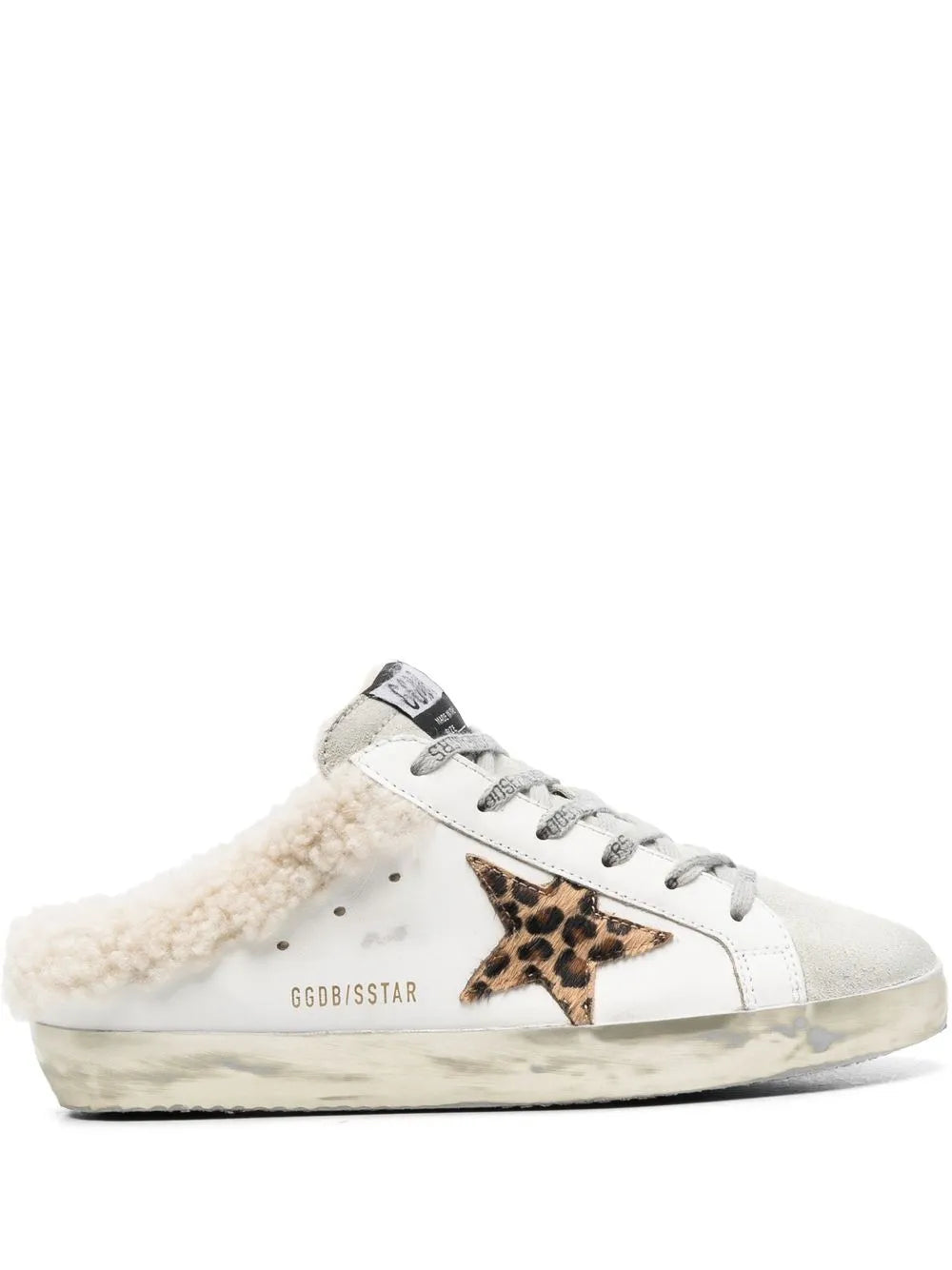 White low-top slip-on sneakers with leopard star patch and tan sherpa lining