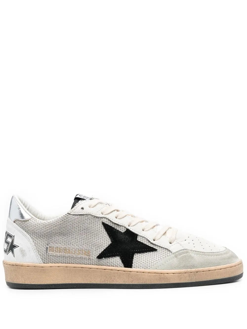 Low-top sneakers with black star patch, white laces, light gray upper, tan sole