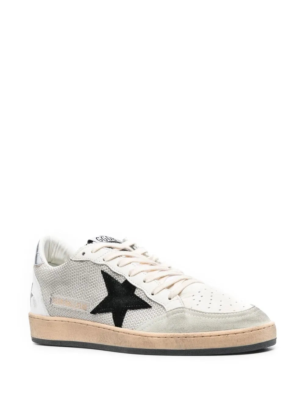 Low-top sneakers with black star detail, white laces, light gray upper, beige-tan sole