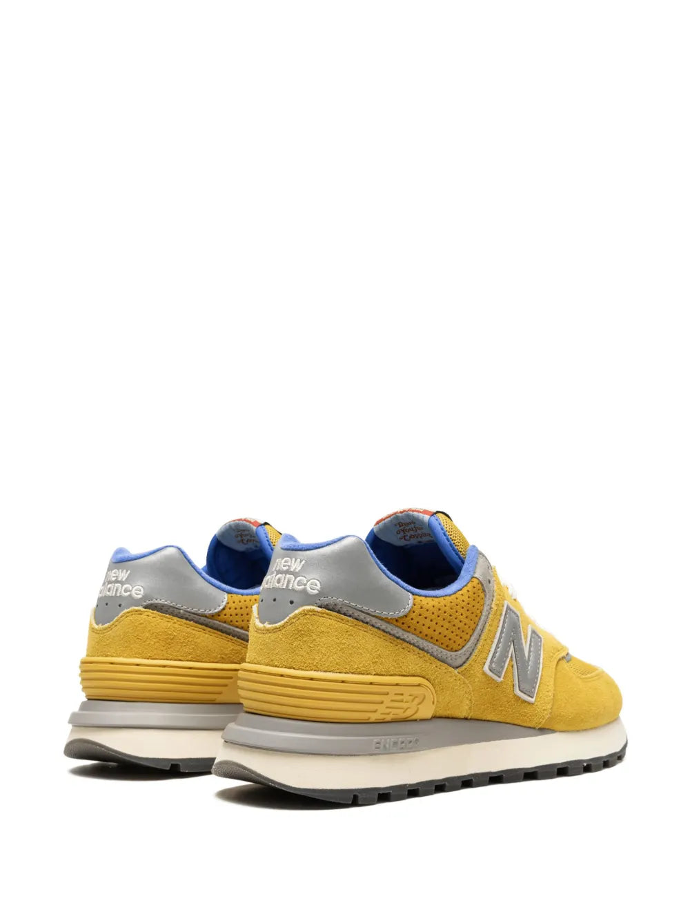 Pair of yellow New Balance 574 sneakers with blue heel tabs and gray N accents