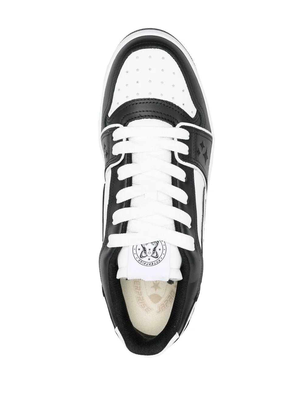 Black and white leather sneakers top view with lace-up and logo tongue