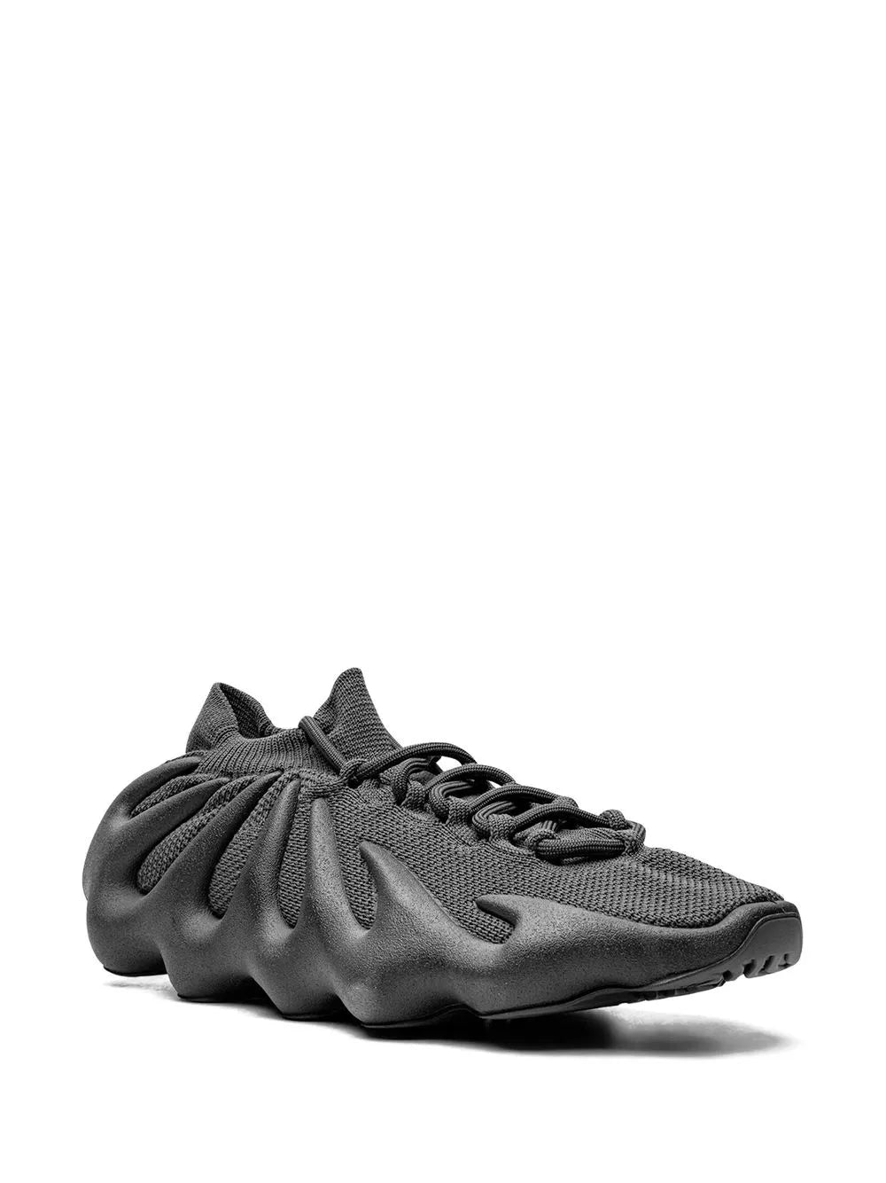 Black Yeezy 450 sneaker in side view with wavy upper and lace closure