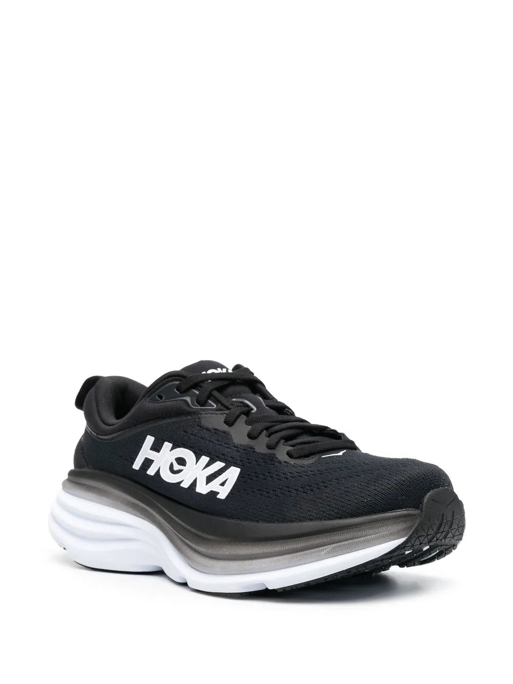 Black lace-up low-top running shoe with sculpted white sole, angled side view
