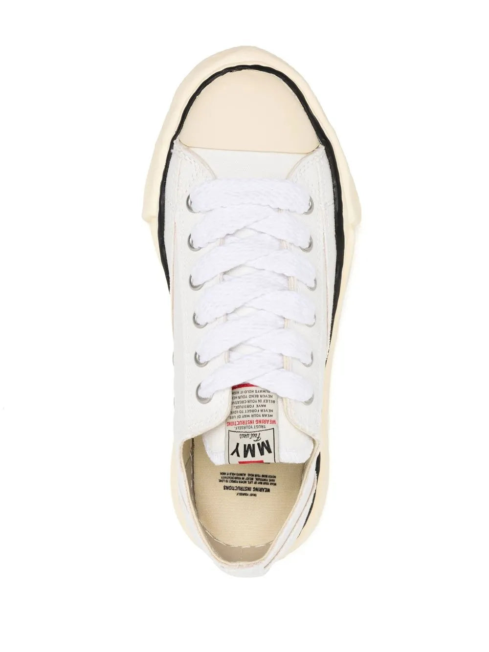 White low-top canvas sneaker, lace-up with inner label visible at open collar