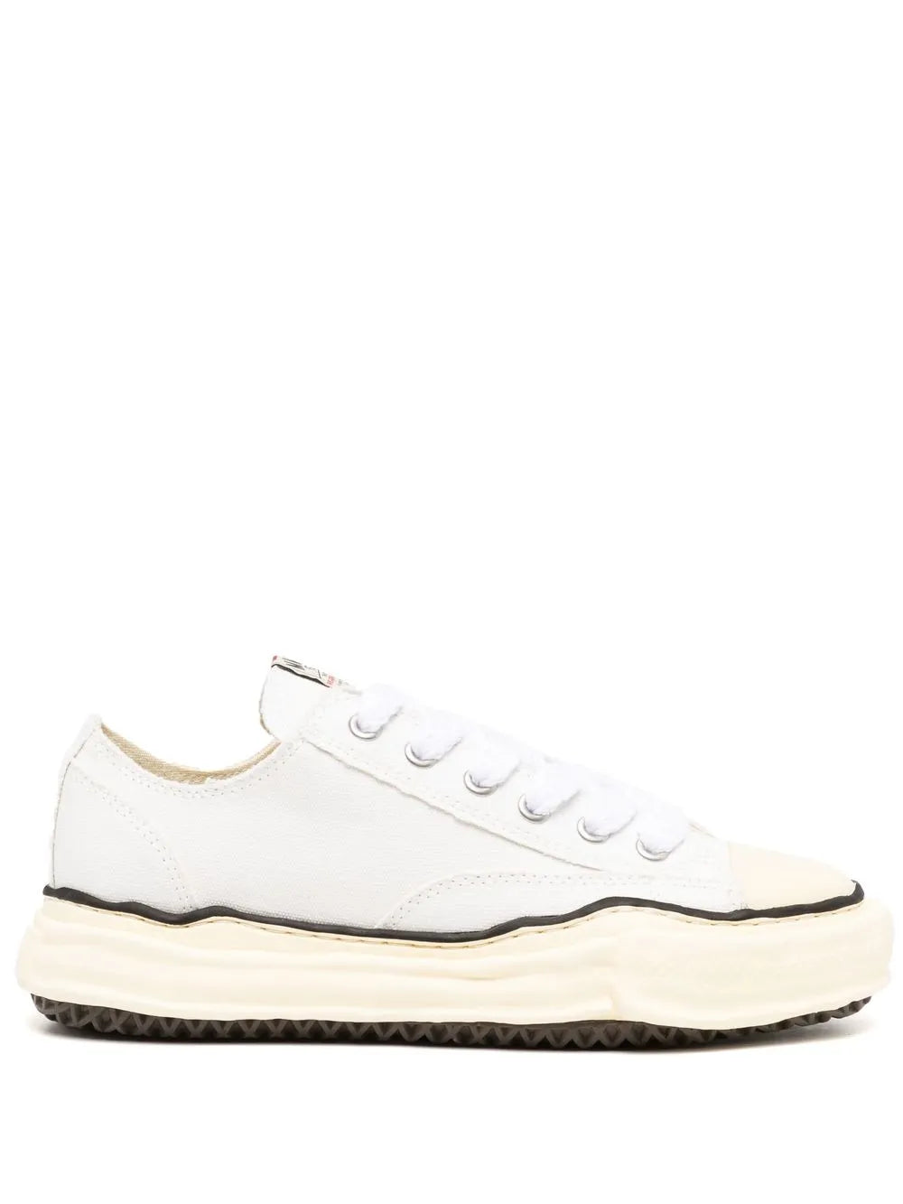 White low-top canvas sneakers, lace-up with rubber toe cap and dark trim