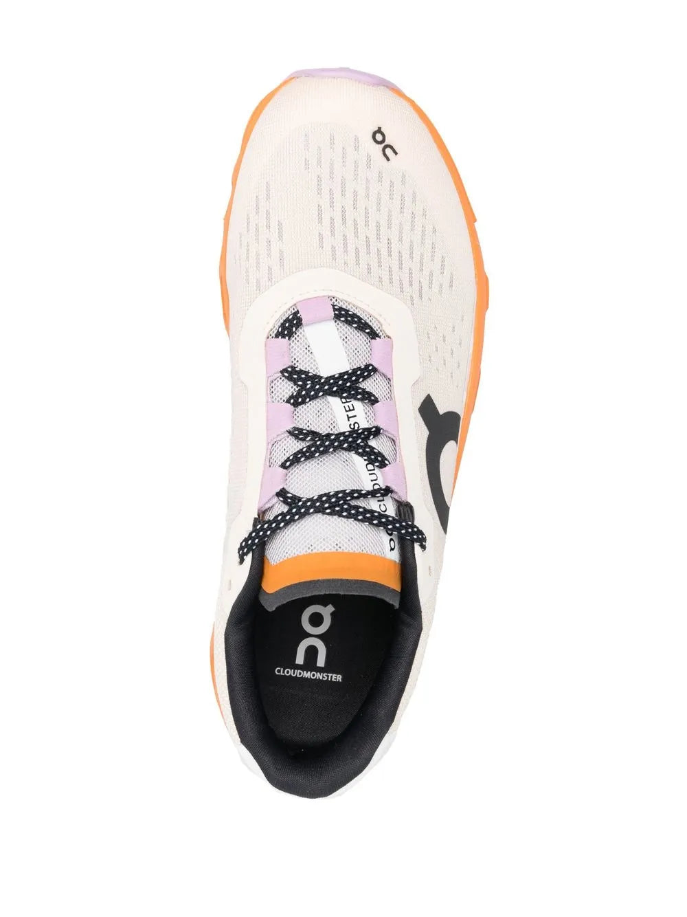 White low-top shoe with black interior logo and orange rubber outsole