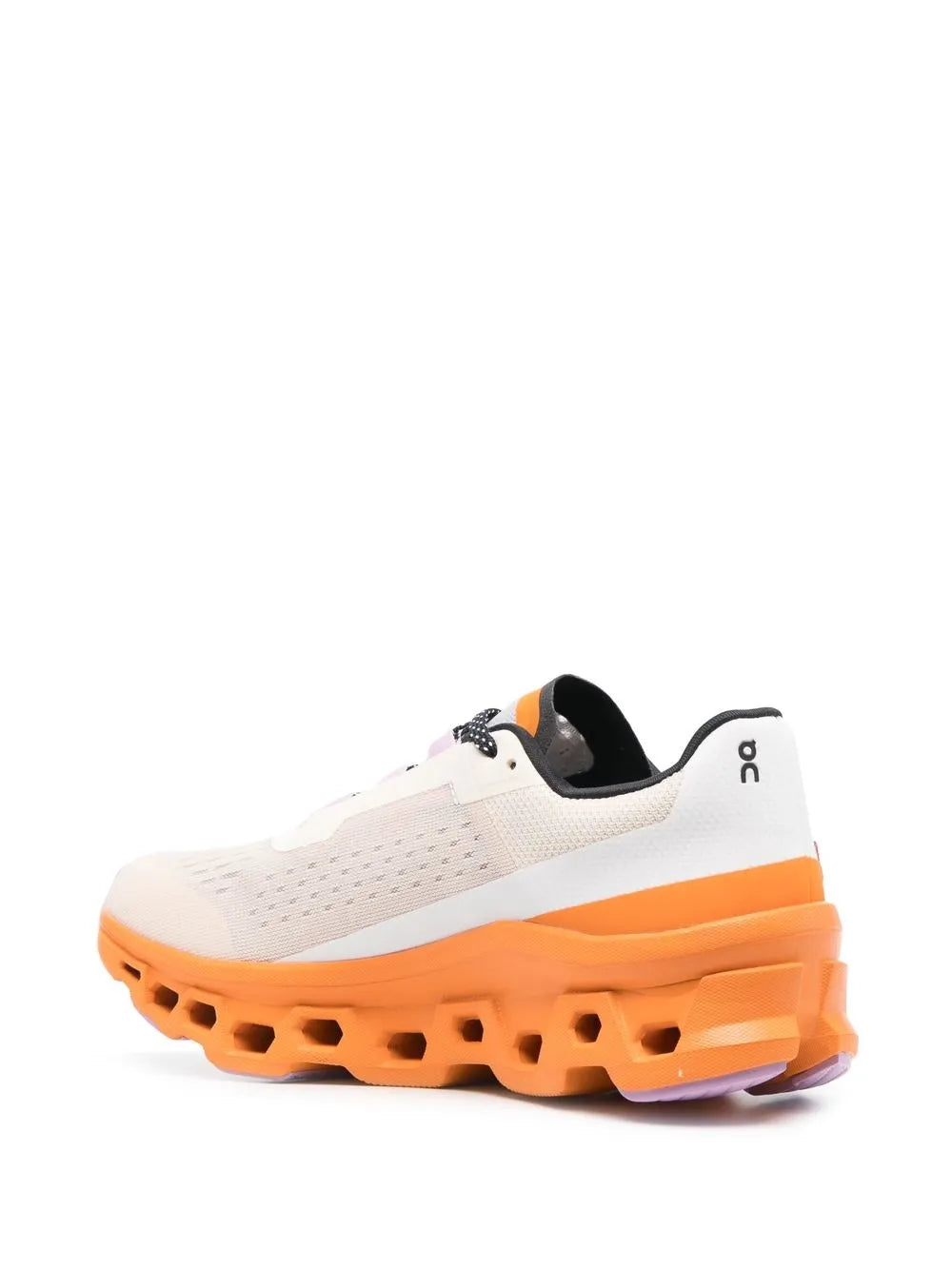 White low-top running shoe with black collar and orange treaded sole