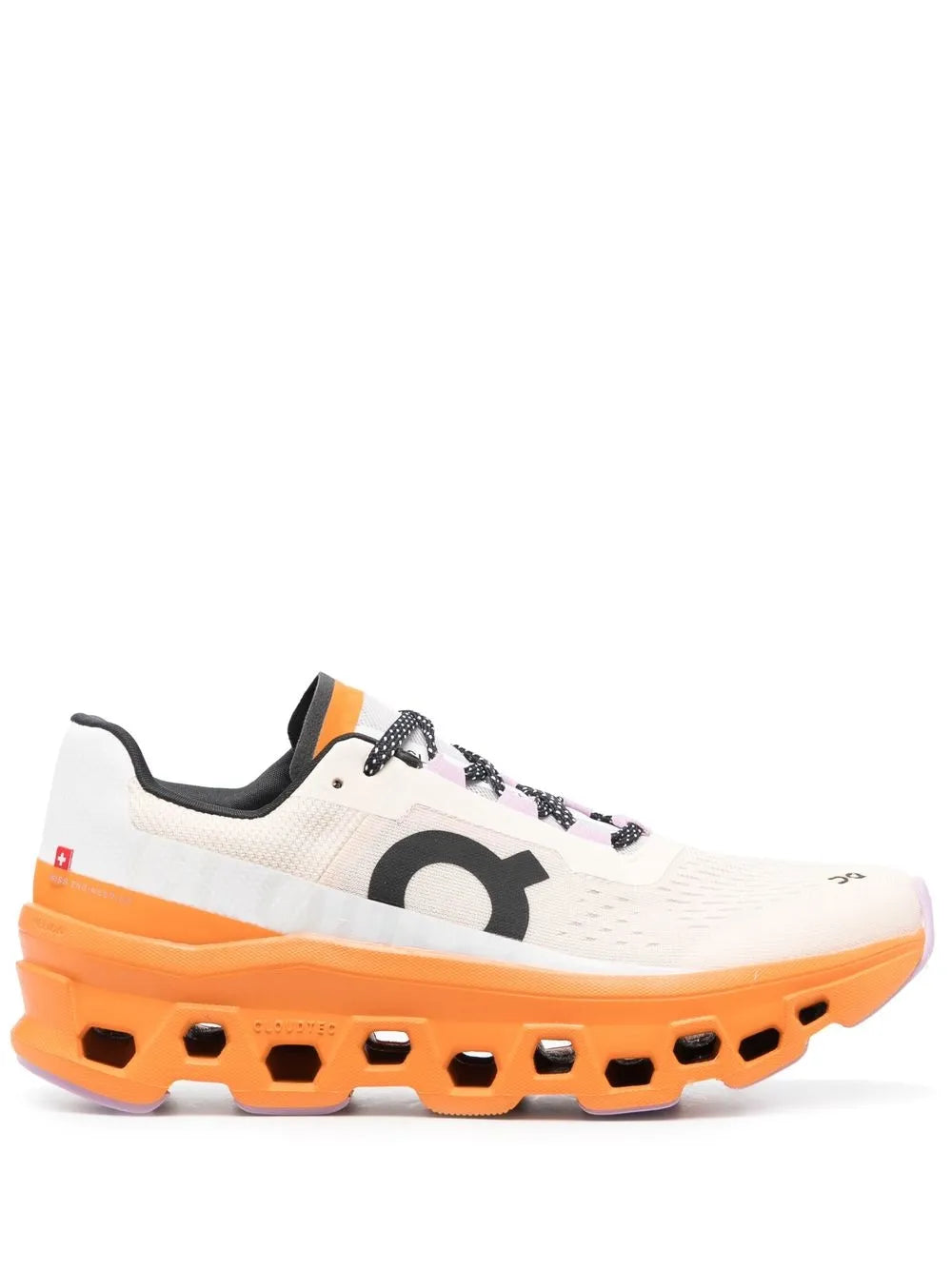 White low-top running shoe with black logo and orange CloudTec sole